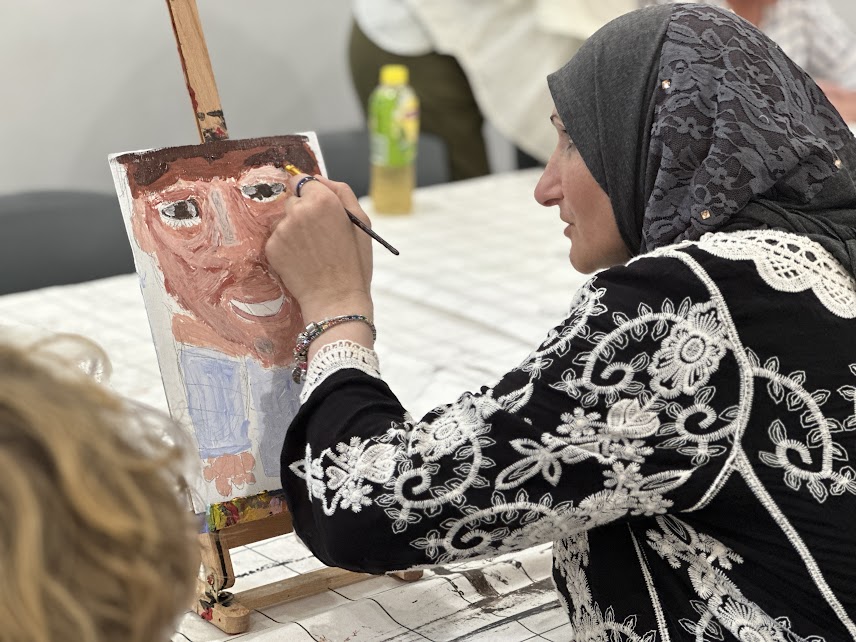 Artist Ruby painting at Studio ARTES Inner West. Image courtesy of Studio ARTES.